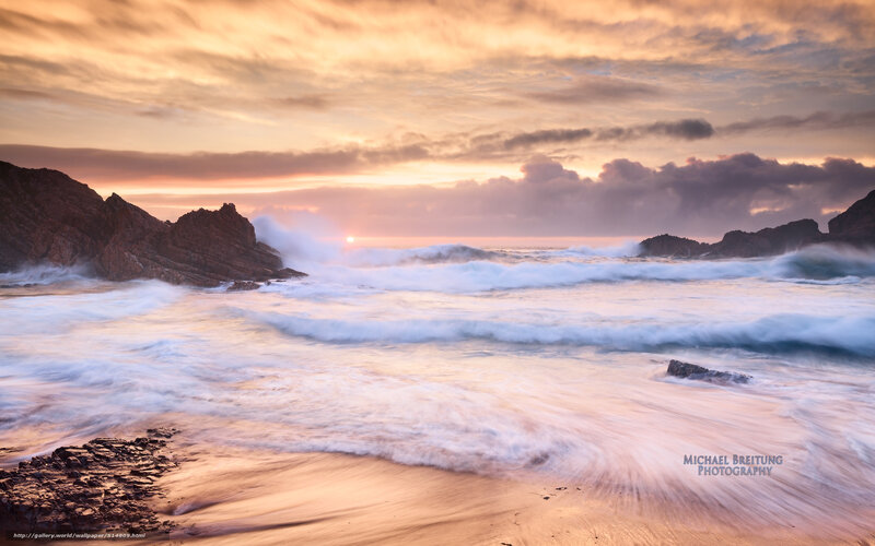 Sunset waves crashing on rocks