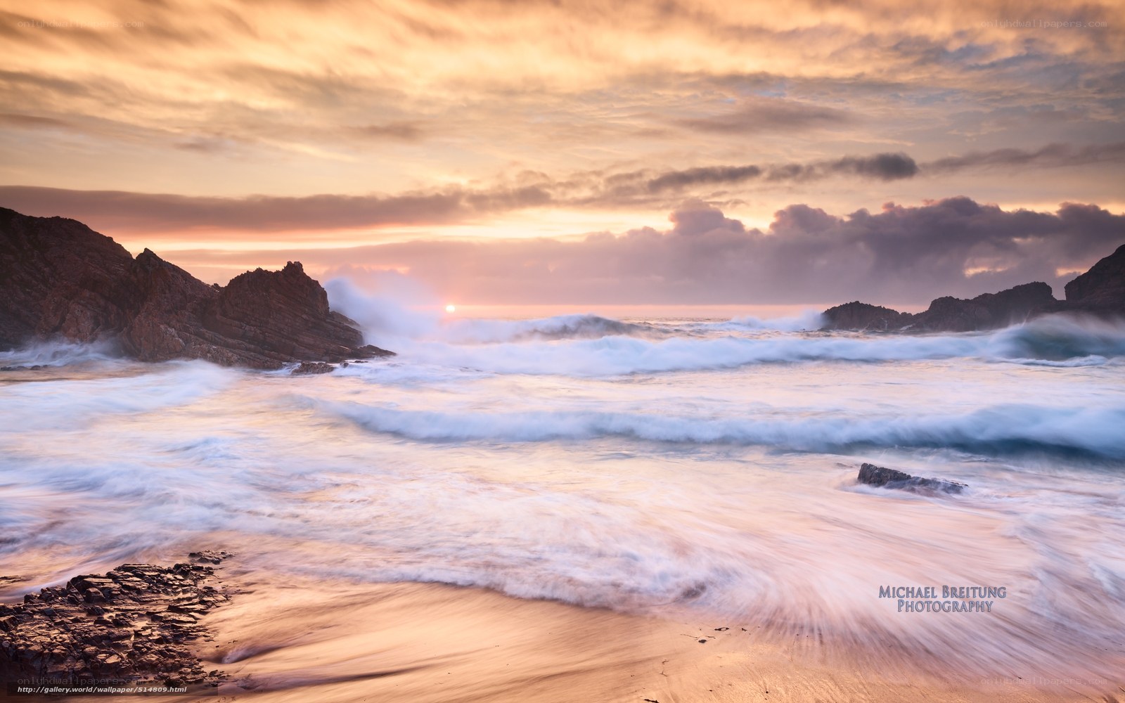 Sunset waves crashing on rocks