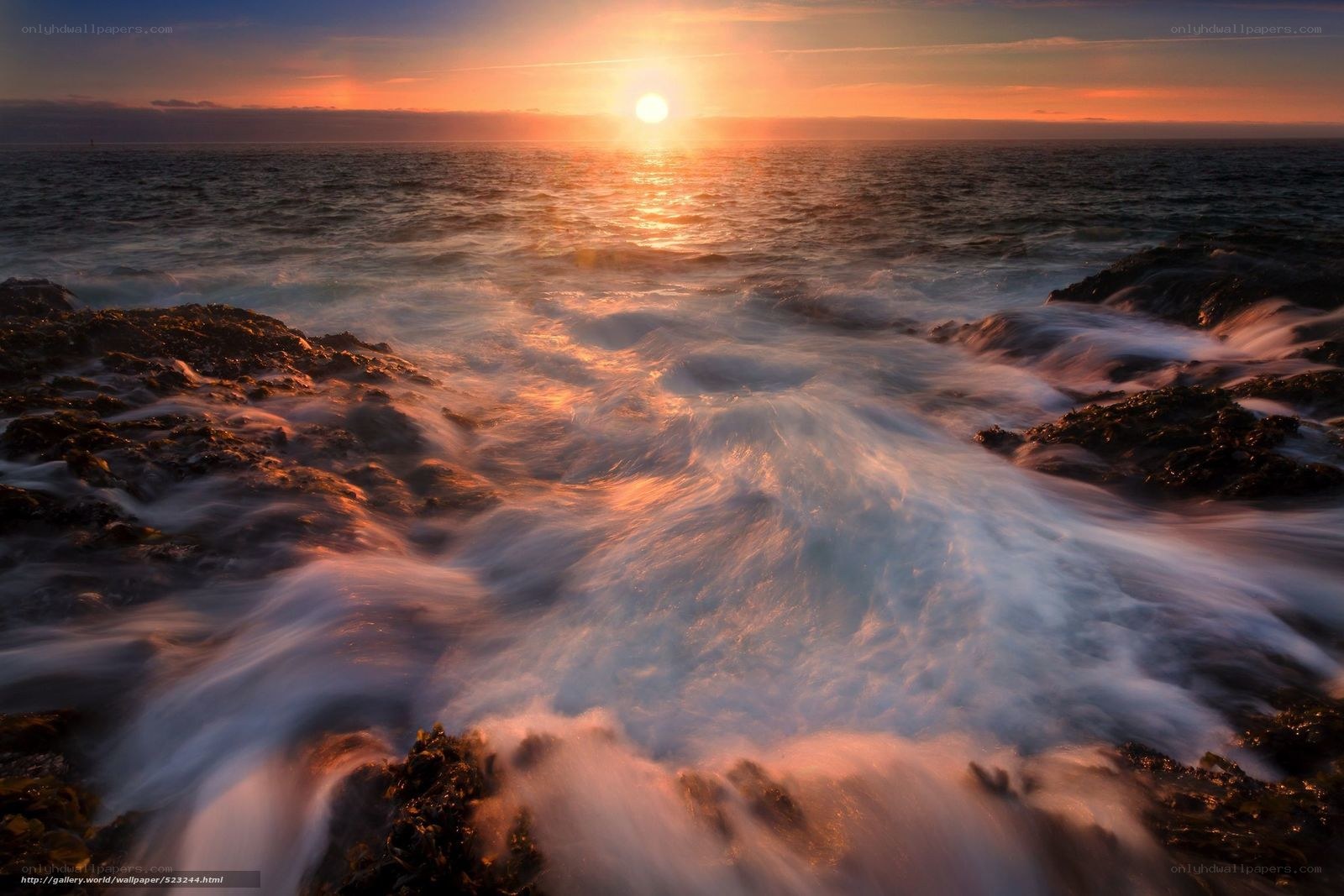 Sunset waves crashing on rocks