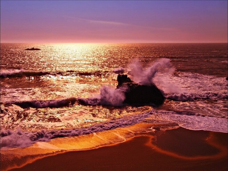 Sunset waves crashing on rocks