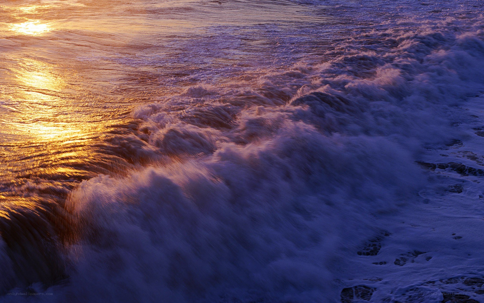 Sunset waves crashing on shore