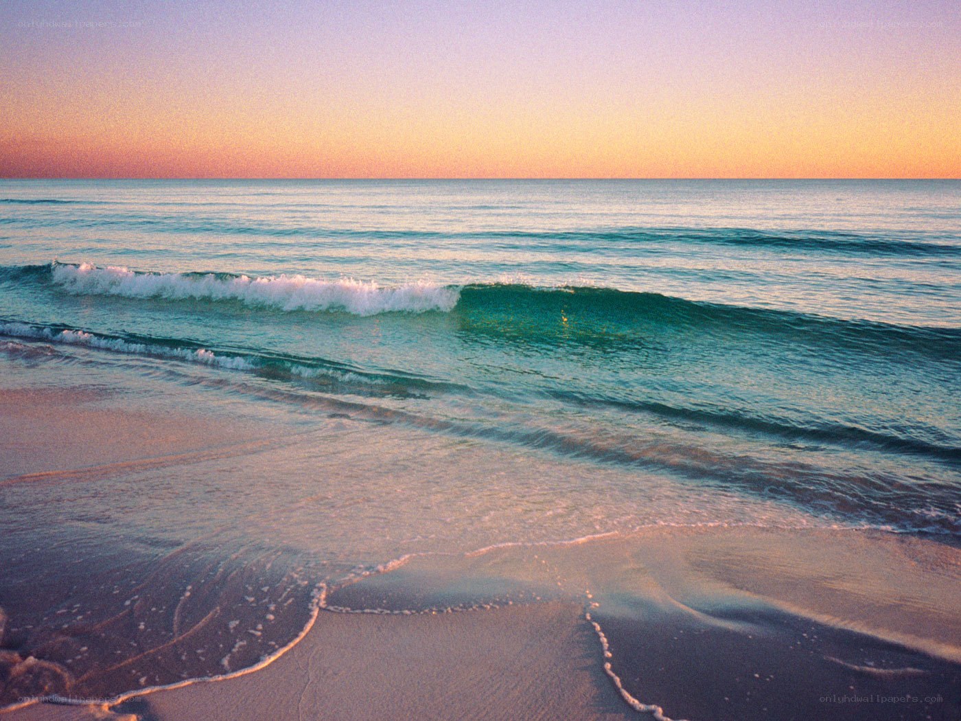 Sunset waves on a quiet beach