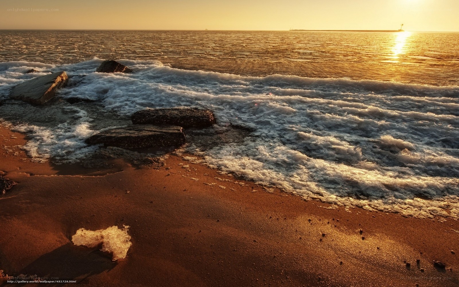 Sunset waves on a rocky beach