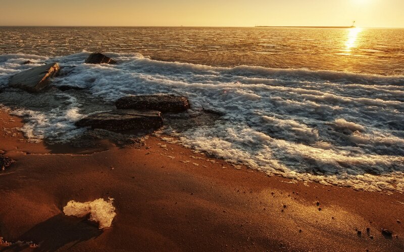 Sunset waves on a rocky shore