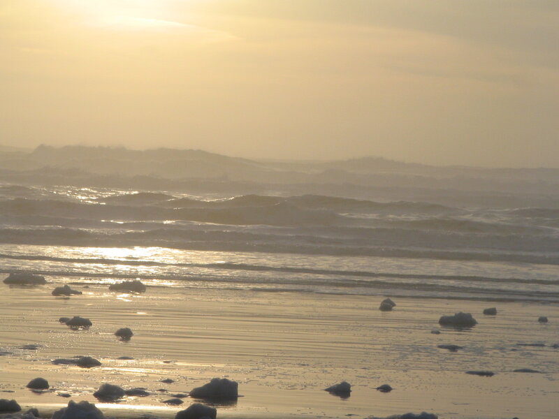 Sunset waves on a sandy beach