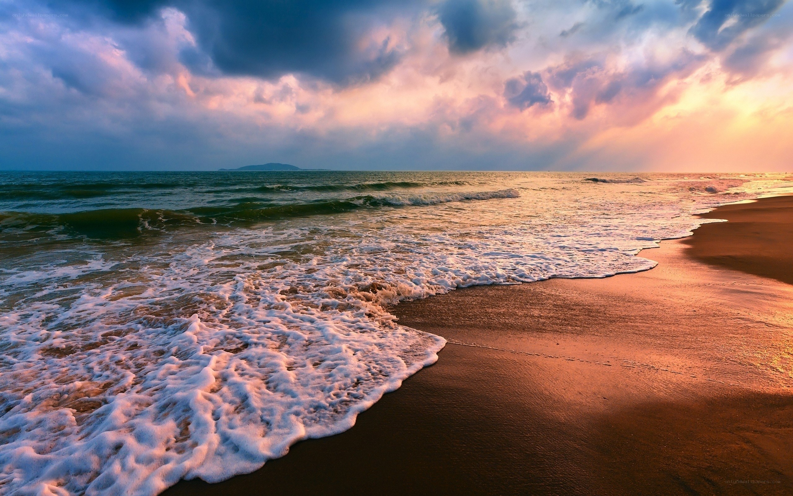 Sunset waves on a sandy beach