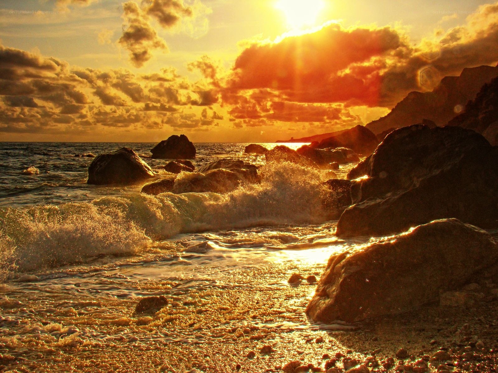 Sunset waves on rocky shore
