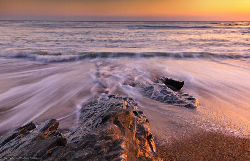 Sunset waves on rocky shore