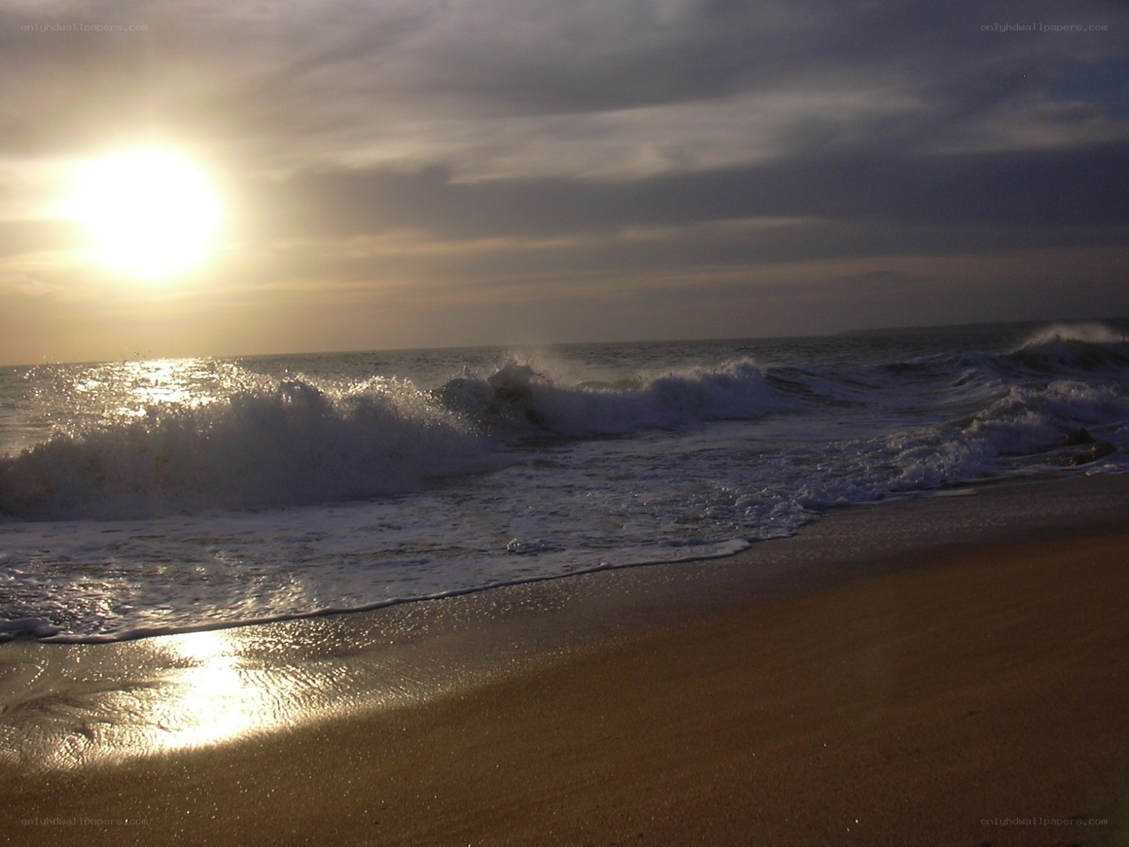 Sunset waves on sandy beach