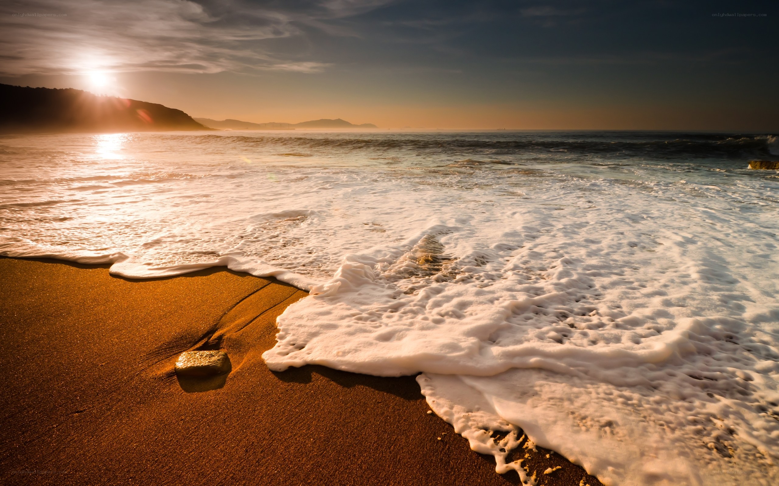Sunset waves on sandy beach