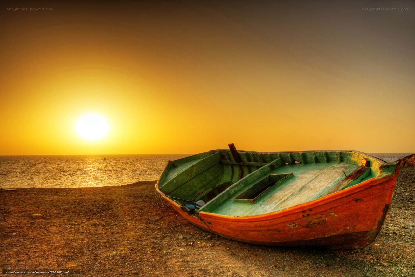 Sunset with a boat on the shore