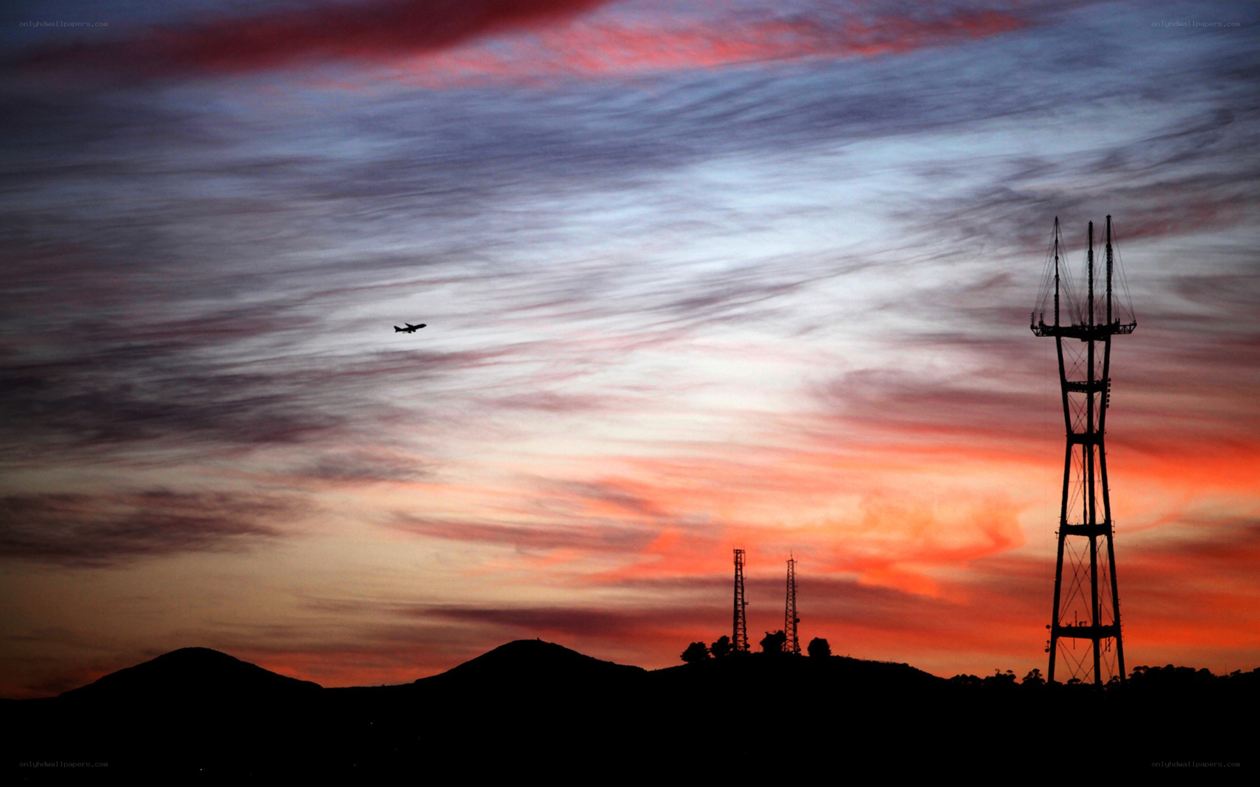 Sunset with airplane and towers