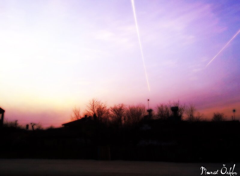 Sunset with airplane trails