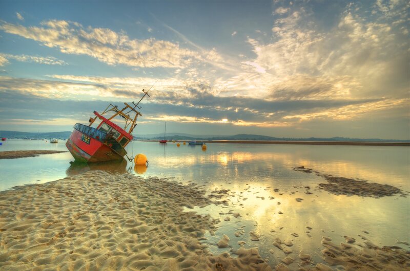 Sunset with beached fishing boat