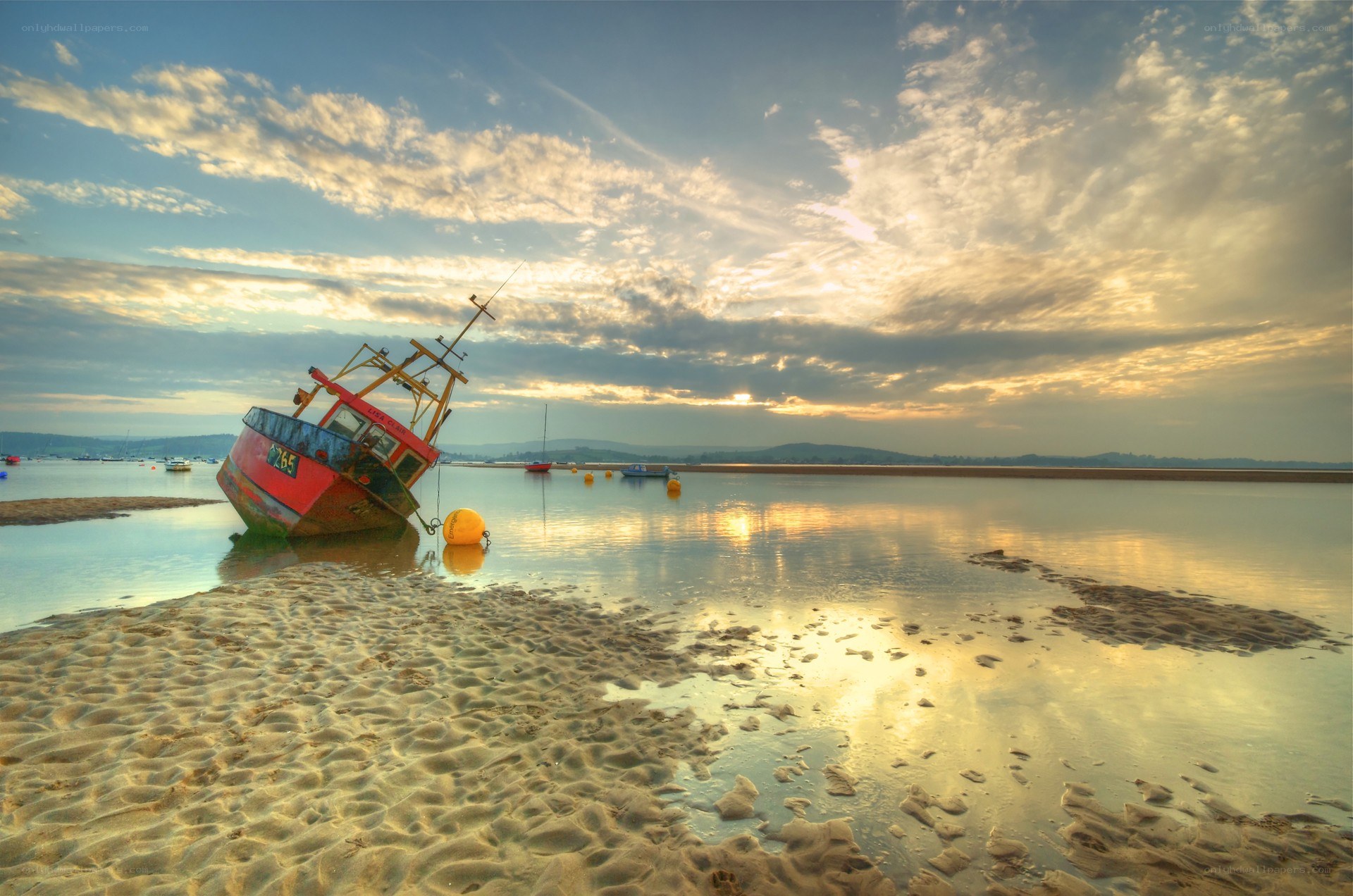 Sunset with beached fishing boat