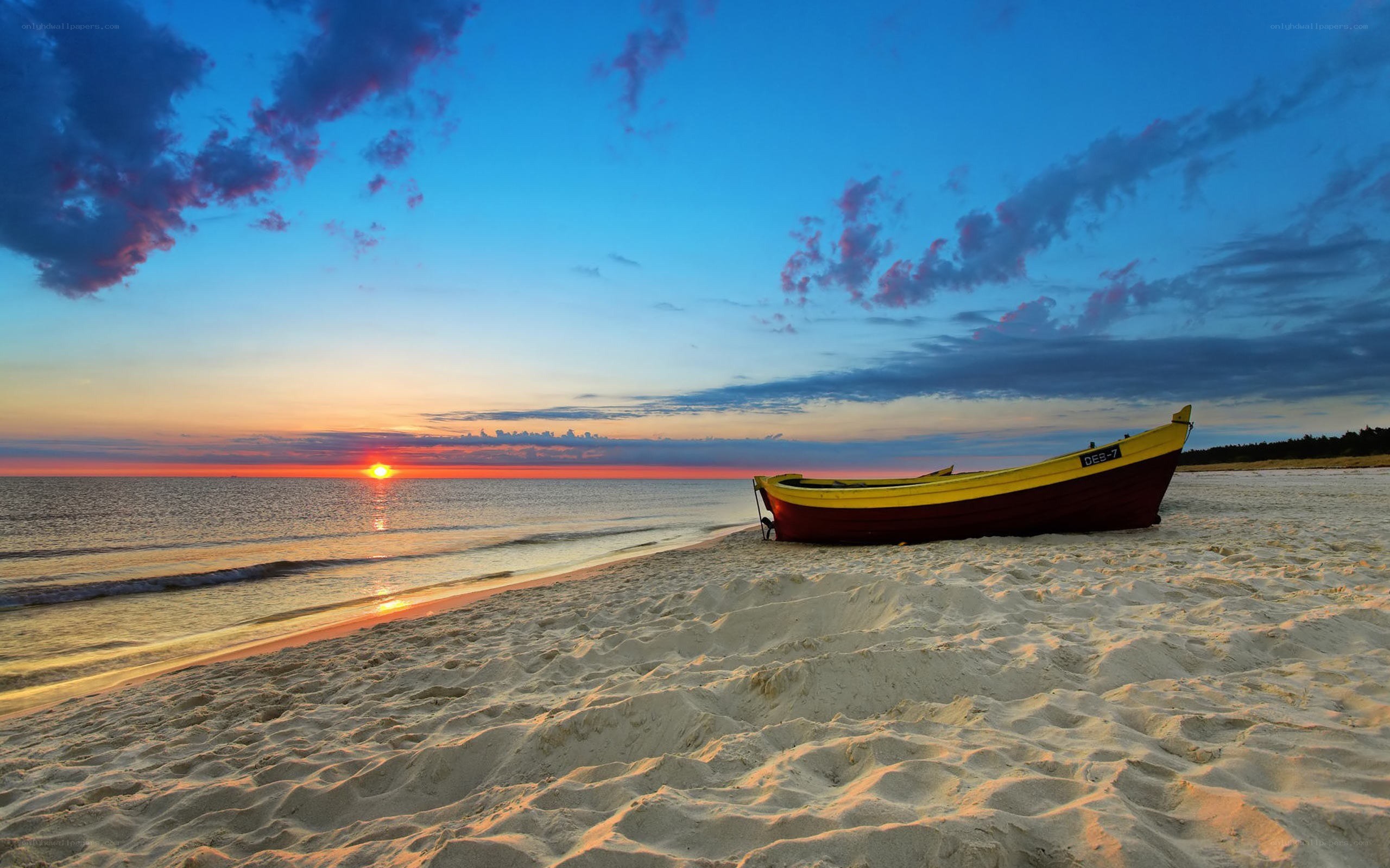 Sunset with boat on beach