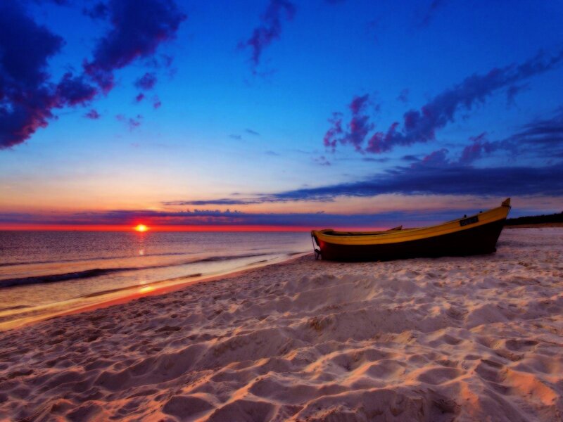 Sunset with boat on beach
