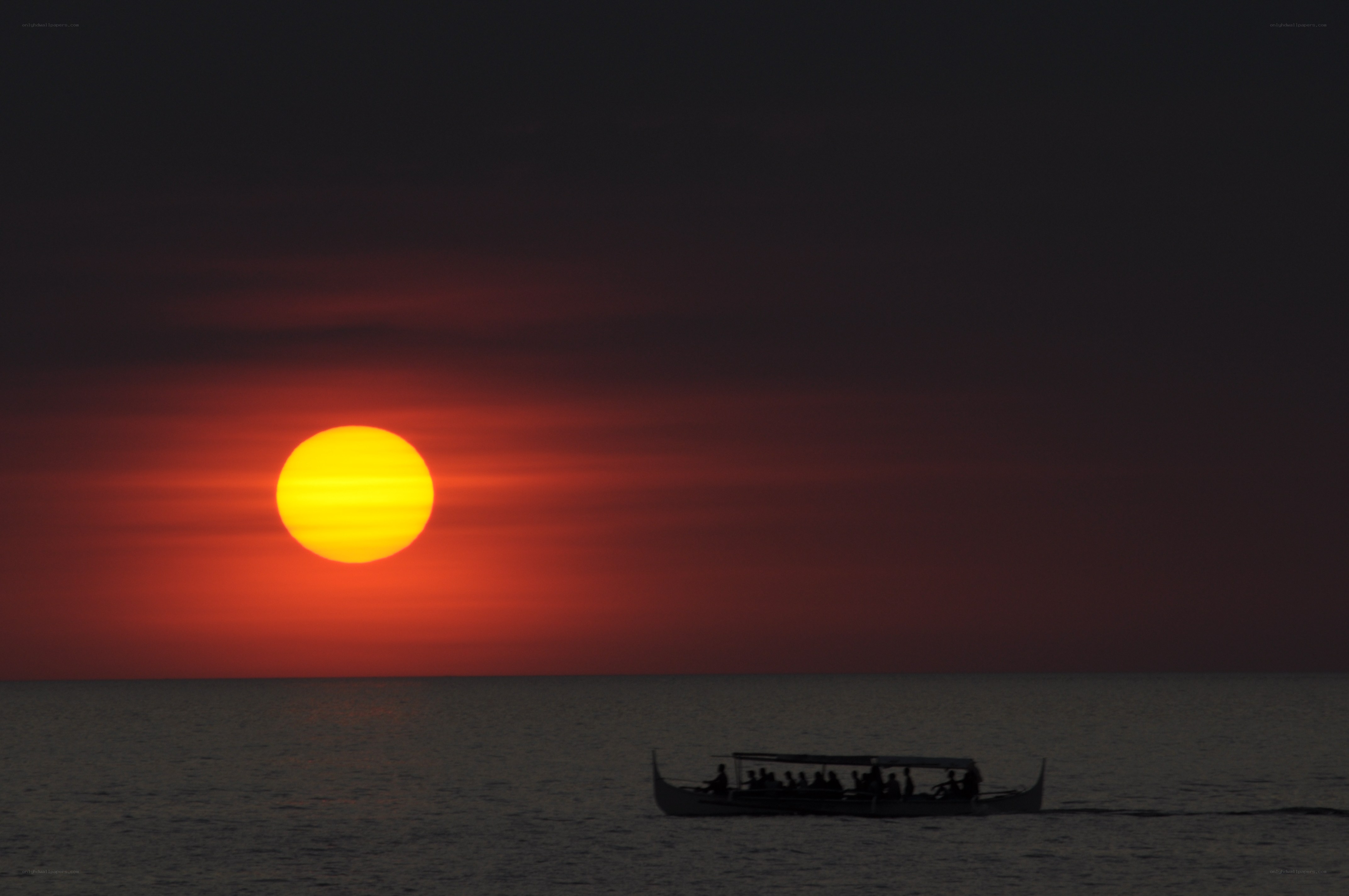 Sunset with boat silhouette