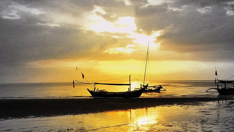 sunset with boats on beach