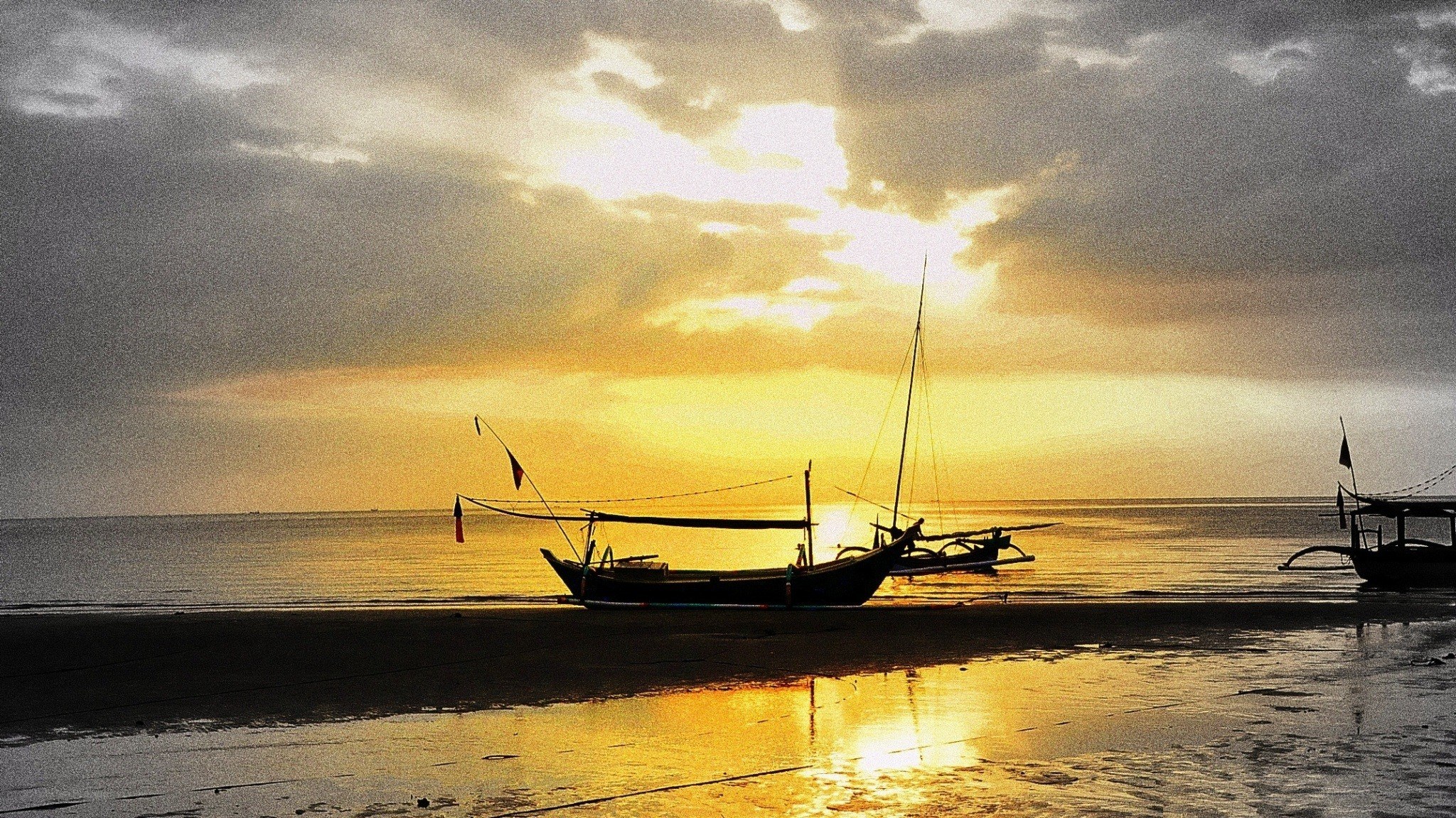 sunset with boats on beach