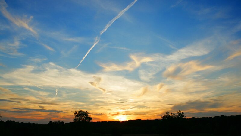 sunset with contrail