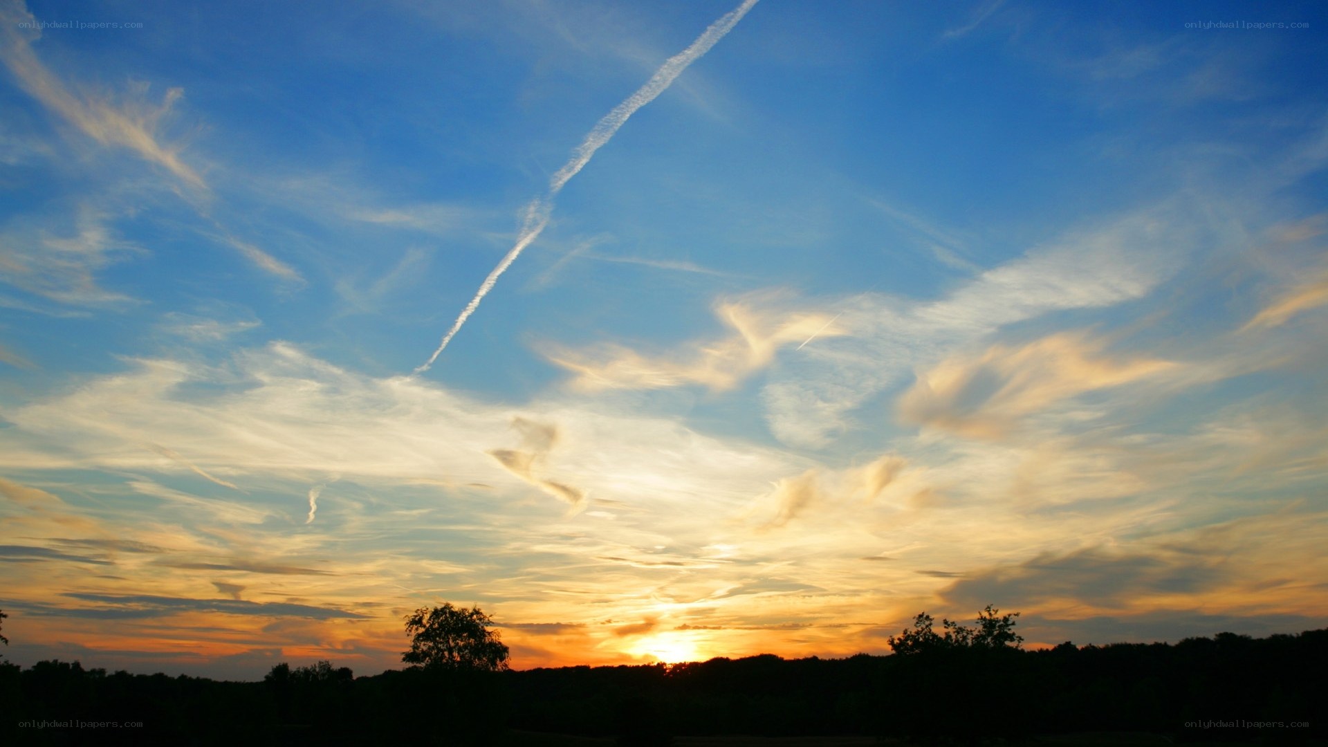 sunset with contrail