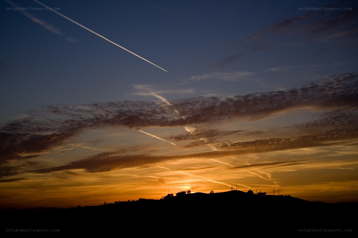 Sunset with contrails