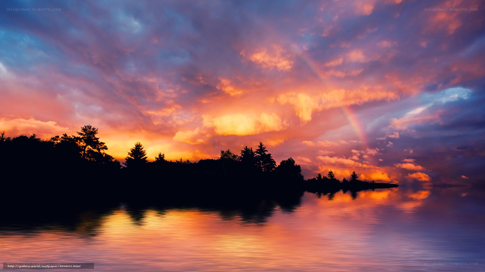 Sunset with rainbow over lake