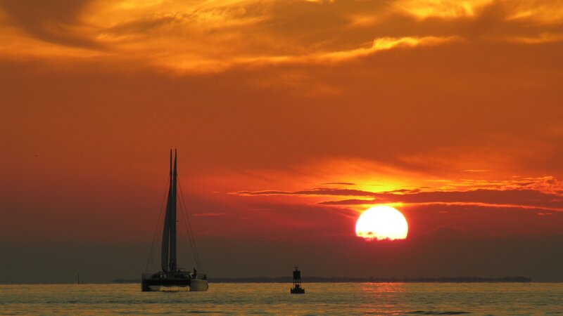 Sunset with sailboat silhouette