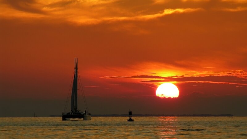 Sunset with sailboat silhouette
