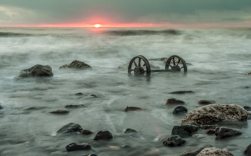 Sunset with shipwreck wheels