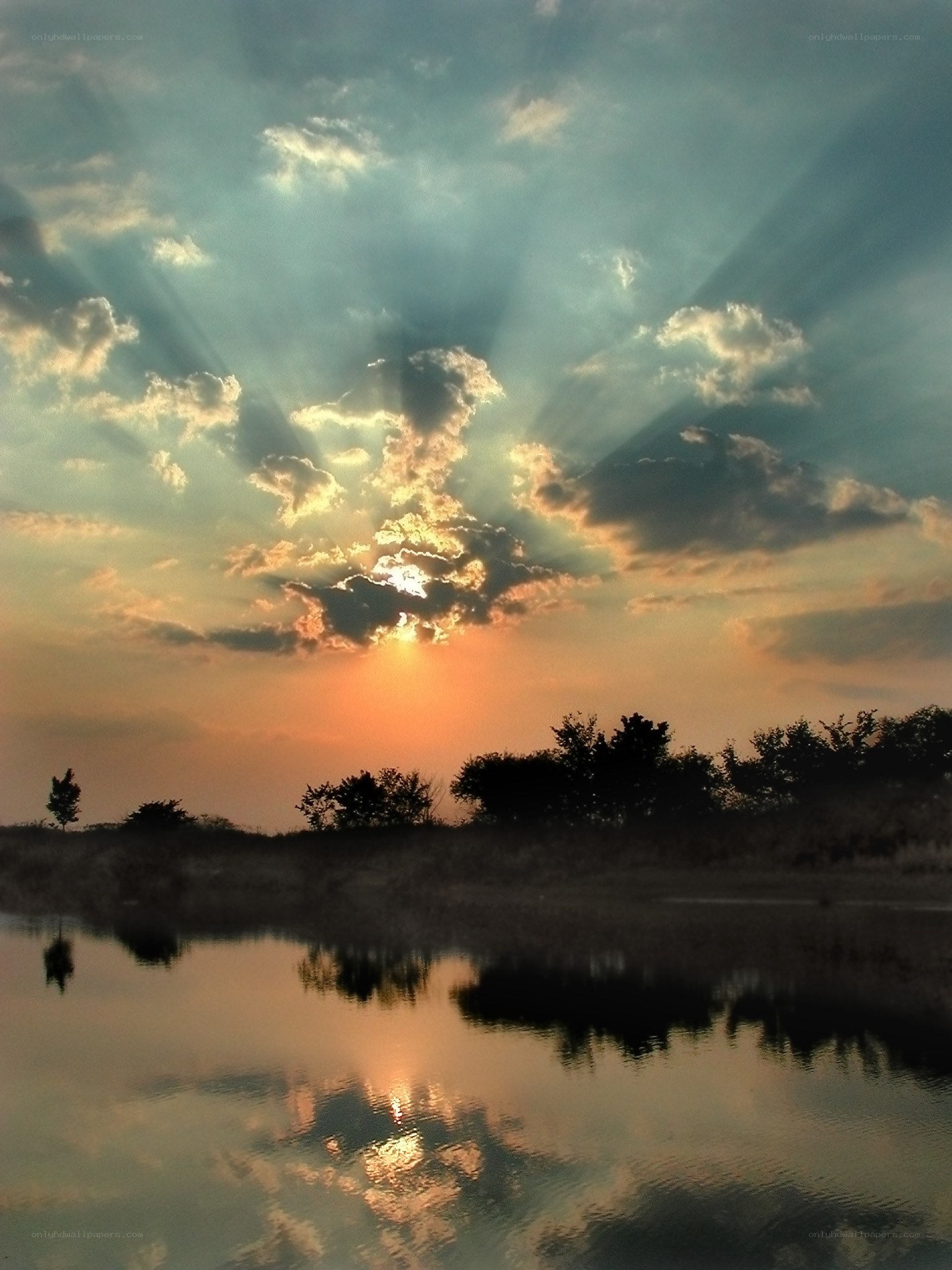 Sunset with sunbeams over water