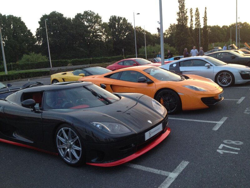 Supercar gathering at dusk