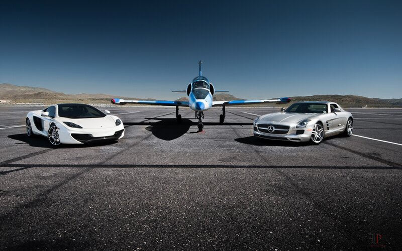 Supercars and jet on tarmac