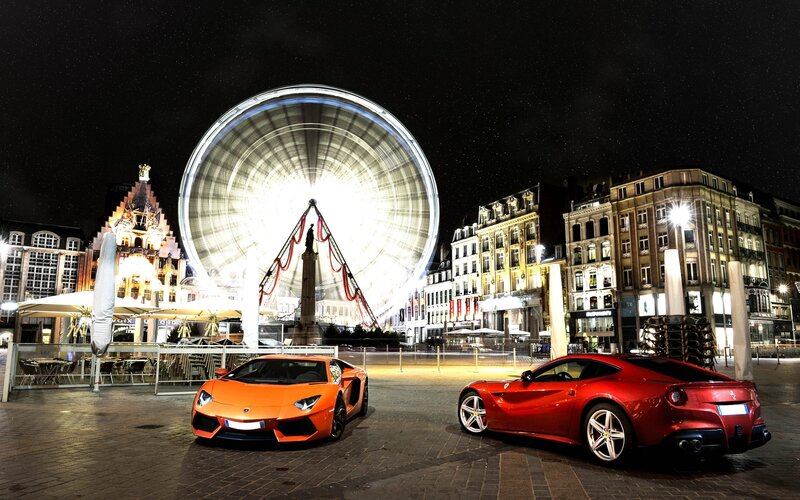 Supercars at night in a city square