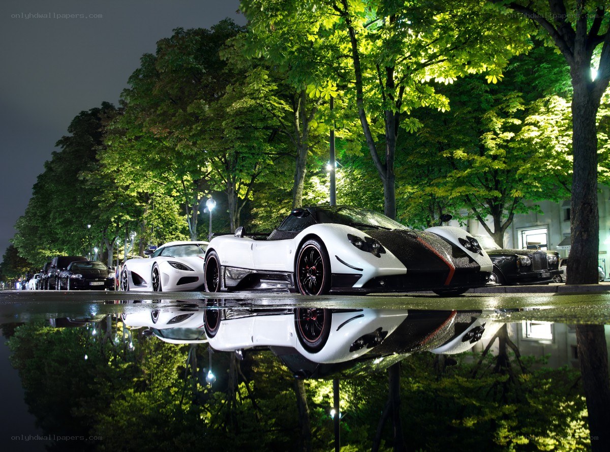Supercars at night in a puddle