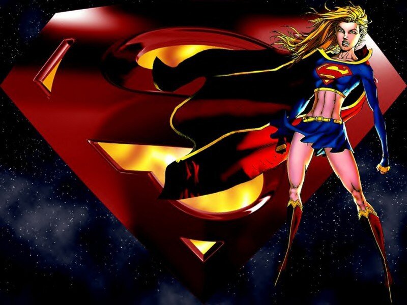 Supergirl in front of S-shield