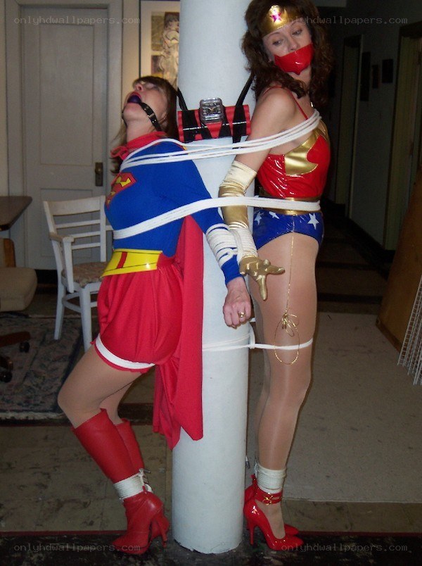 Superhero cosplayers tied to a pole