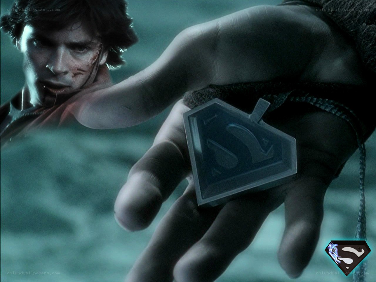 Superman holding his emblem