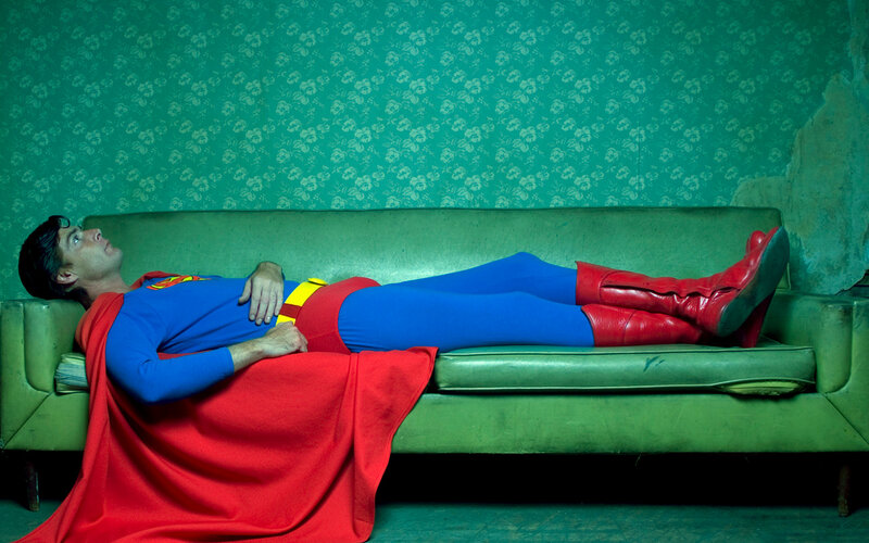 Superman resting on a couch