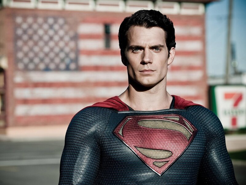 Superman stands before flag