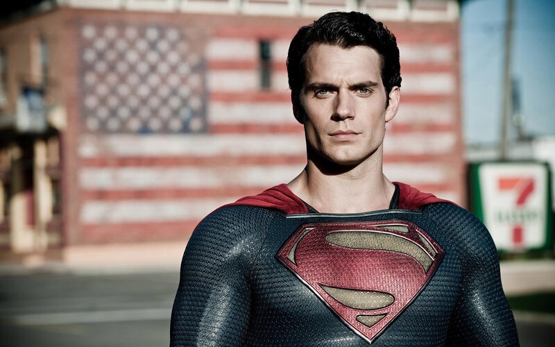 Superman stands before flag