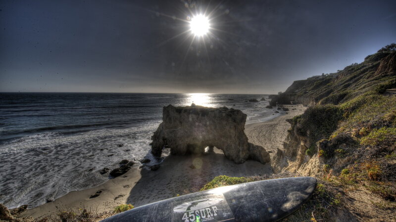 Surfboard on Cliff — Blue