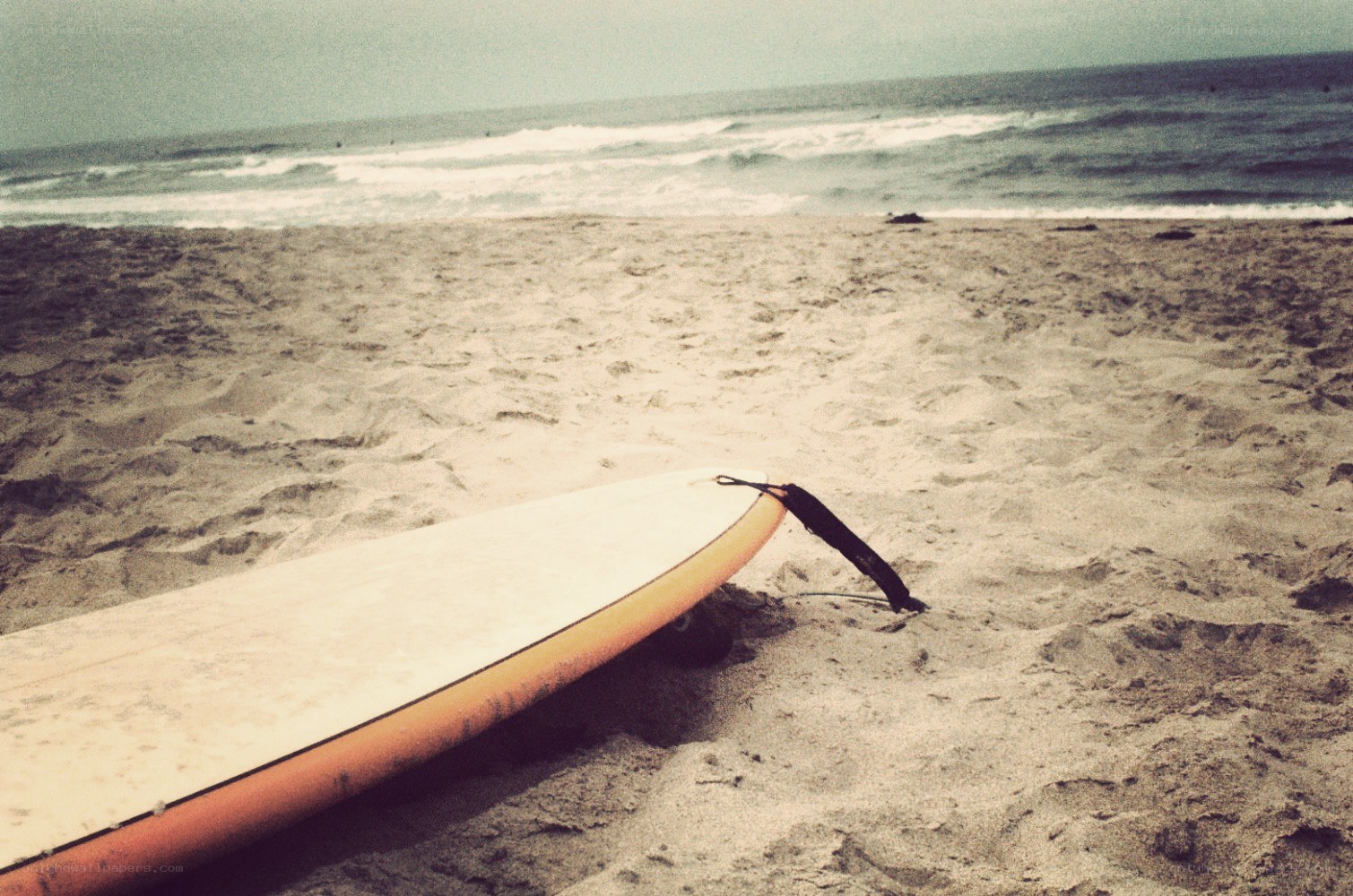 surfboard on sandy beach