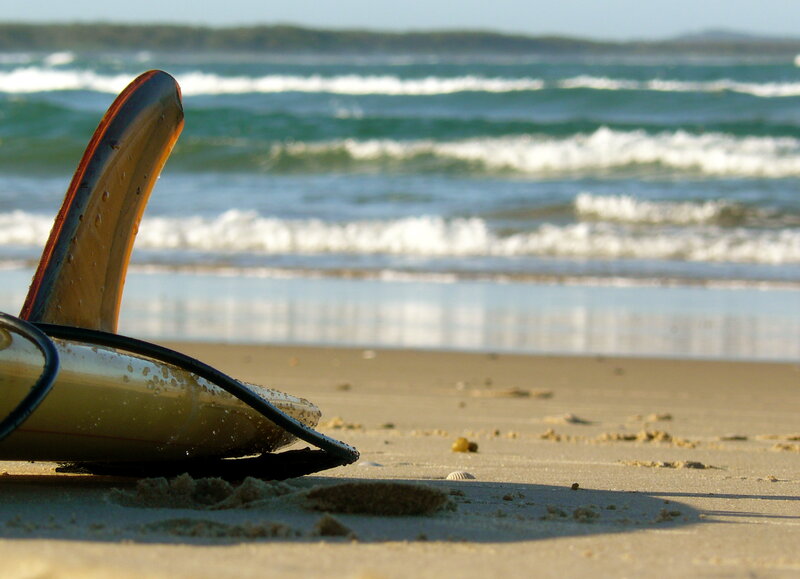 Surfboard on sandy beach