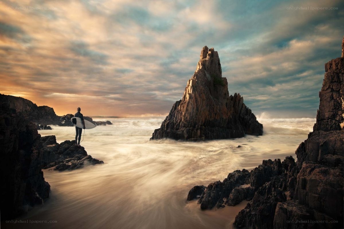 Surfer at coastal rock formation