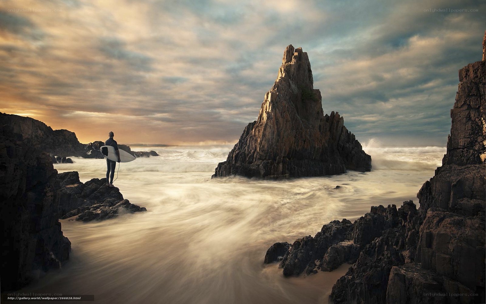 Surfer at coastal rock formation