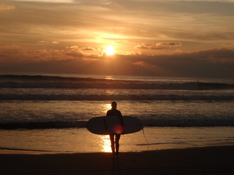 Surfer at sunset on the beach