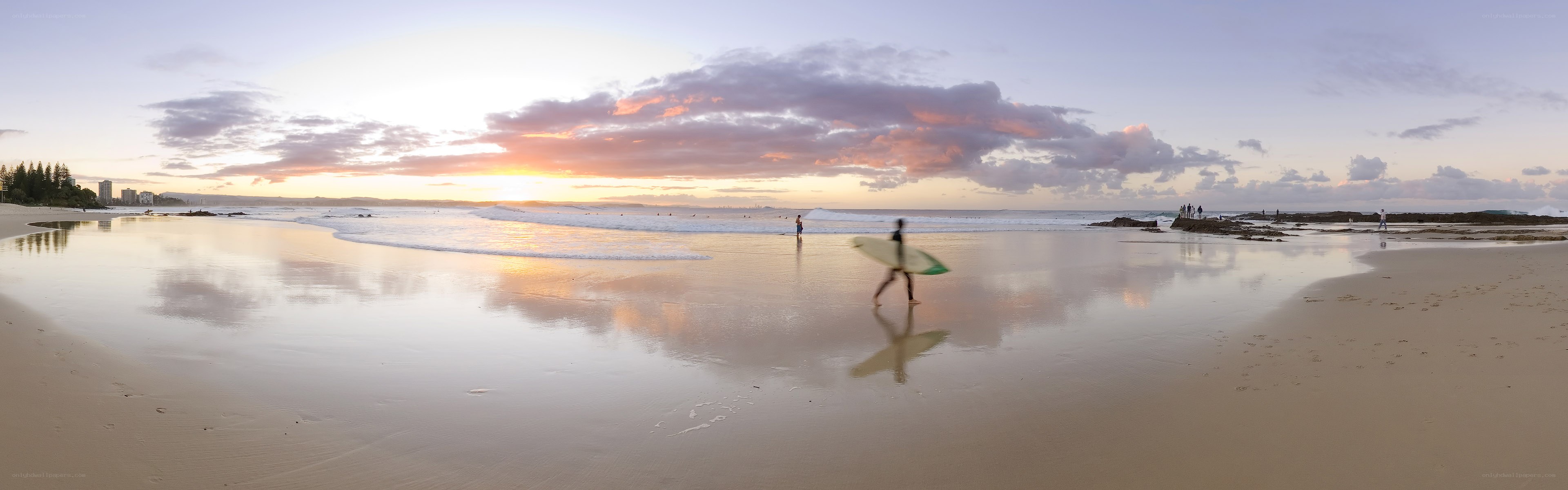 Surfer at sunset on the beach