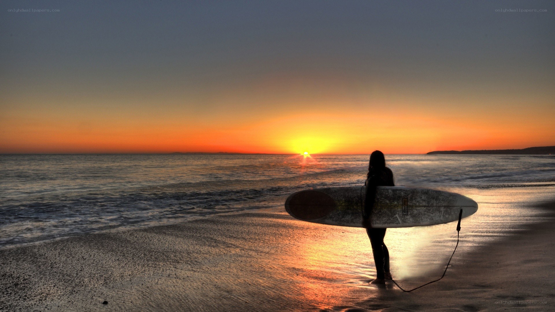 Surfer at sunset on the beach